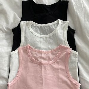 Little girls set of 3 tank tops. 95% cotton 5 % spandex. Size is not indicated.
